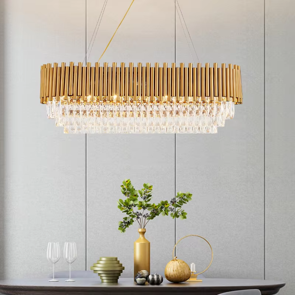 This light luxury double-layer oval chandelier consists of upper gold metal vertical strips and lower faceted crystal pendants. Light refracts through the crystals to emit a brilliant glow, serving both lighting and decorative purposes, suitable for high-end spaces such as villa living rooms and light luxury dining rooms.