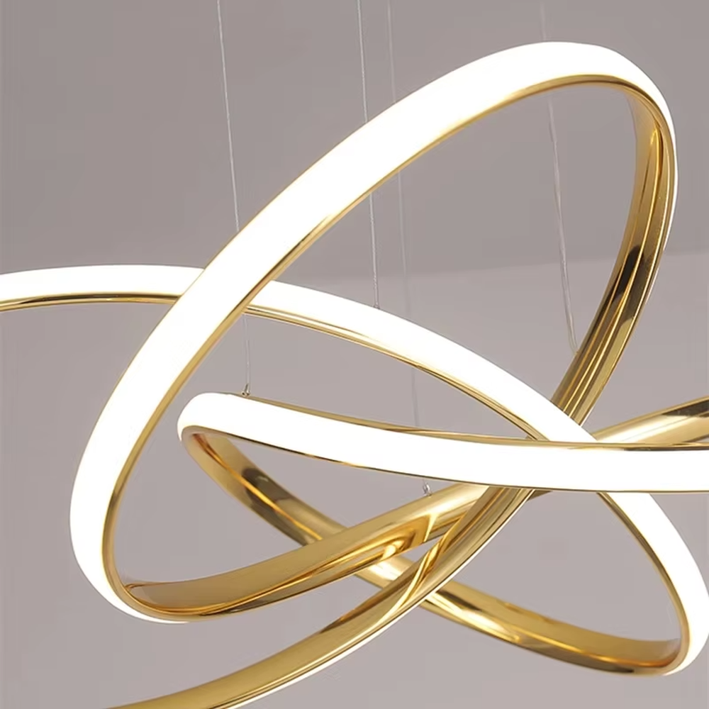 A modern light luxury style interwoven ring LED chandelier, featuring a smooth interwoven multi-ring frame made of gold metal, with built-in high-brightness LED strips. It emits soft and uniform warm light when lit, combining decorative appeal with practical illumination, ideal for creating a minimalist and sophisticated space atmosphere.