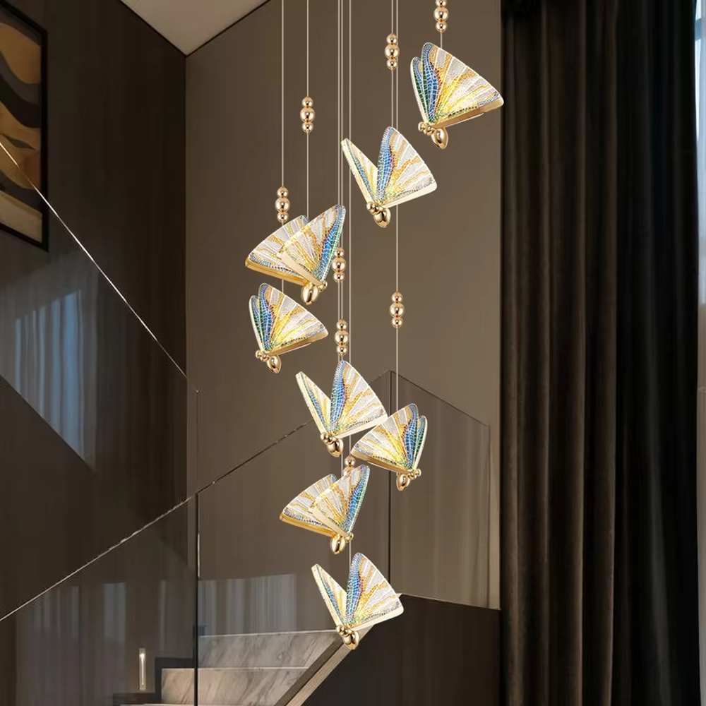 Light luxury butterfly-wing shaped chandelier, featuring butterfly wing textures made of colored mosaic glass, paired with a gold metal base and hanging structure. It emits soft, transparent, and colorful light, combining artistic decorativeness and lighting function, suitable for atmosphere creation and supplementary lighting in spaces such as entrances, stairwells, and bedroom nightstands.