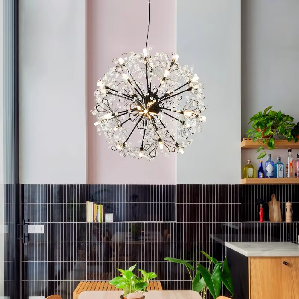 This light luxury dandelion-shaped crystal chandelier features a spherical structure with metal arms and crystal ornaments, with light refracting a brilliant halo through the crystals, serving both lighting and decorative purposes, suitable for modern light luxury spaces such as living rooms and dining rooms.