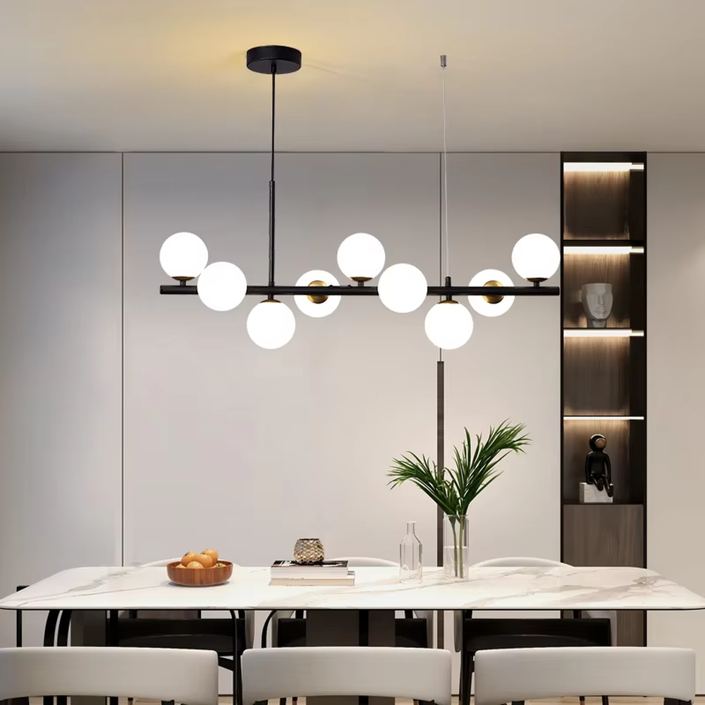 Modern minimalist long strip molecular ball chandelier, with a black and gold metal long rod and milky white glass ball lampshades, featuring a flexible and lightweight linear molecular structure, soft and uniform light, combining decorative and lighting functions, suitable for dining rooms, bars, living rooms and other modern style spaces.