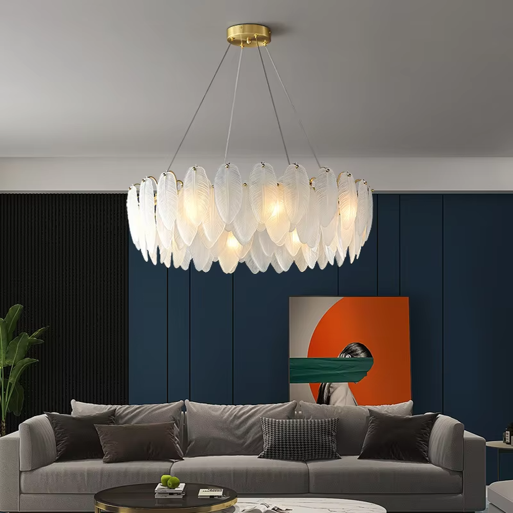 A modern light luxury style ring chandelier, featuring a gold metal frame paired with double-layer feather-shaped gradient glass panels. It emits a soft and warm glow when lit, combining decorative appeal with practical illumination, ideal for creating a romantic and elegant space atmosphere.

