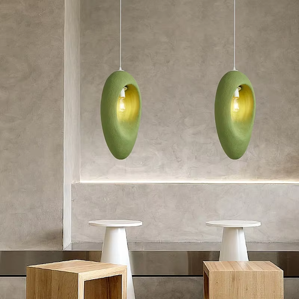 This is a modern wabi-sabi style pebble-shaped pendant lamp, made of frosted cement/resin material with a semi-embedded lighting design, available in colors like gray and green, which has both lighting and decorative functions, suitable for modern minimalist, wabi-sabi style bedrooms, entrances, cafes and other spaces.