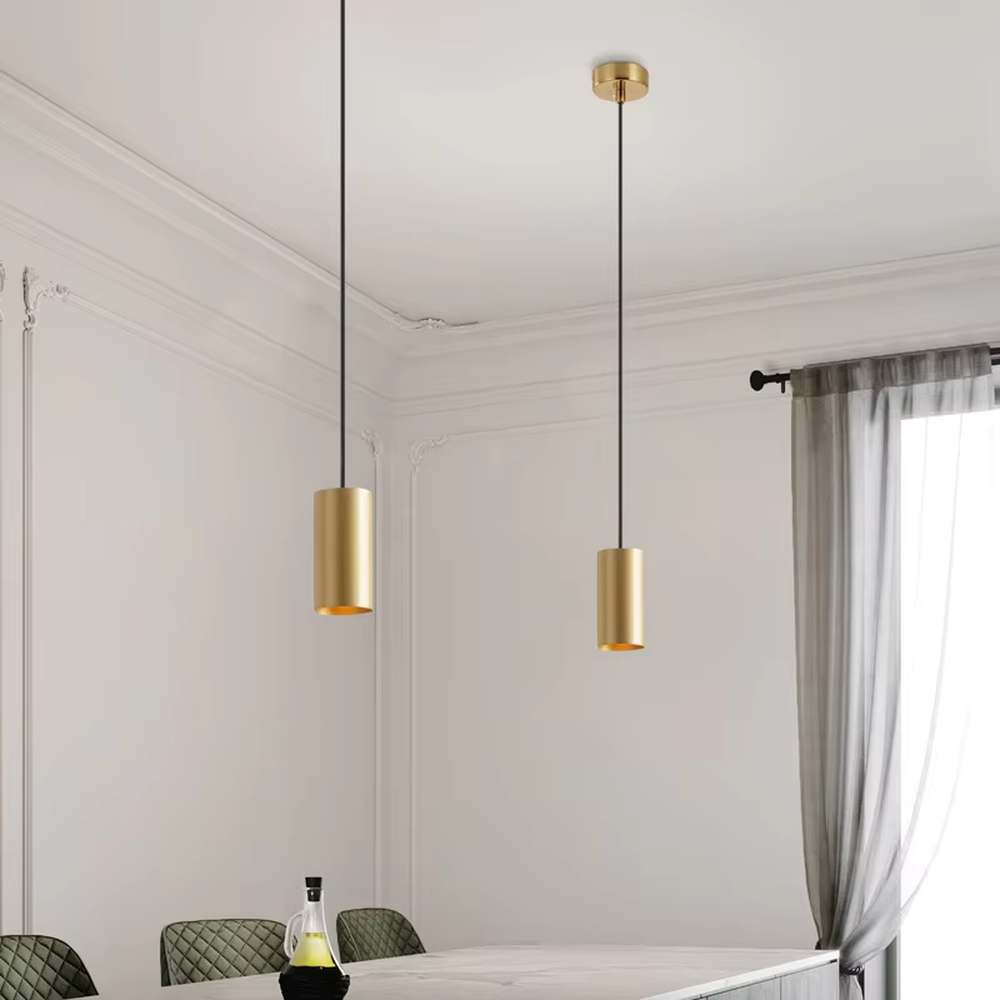 This is a modern light luxury gold cylindrical triple-head pendant light, featuring a linear bronze metal base paired with cylindrical lamp bodies, with a staggered hanging design that is simple and neat. It emits soft and uniform light, serving both lighting and decorative purposes, suitable for dining rooms, bars, minimalist living rooms and other scenarios.
