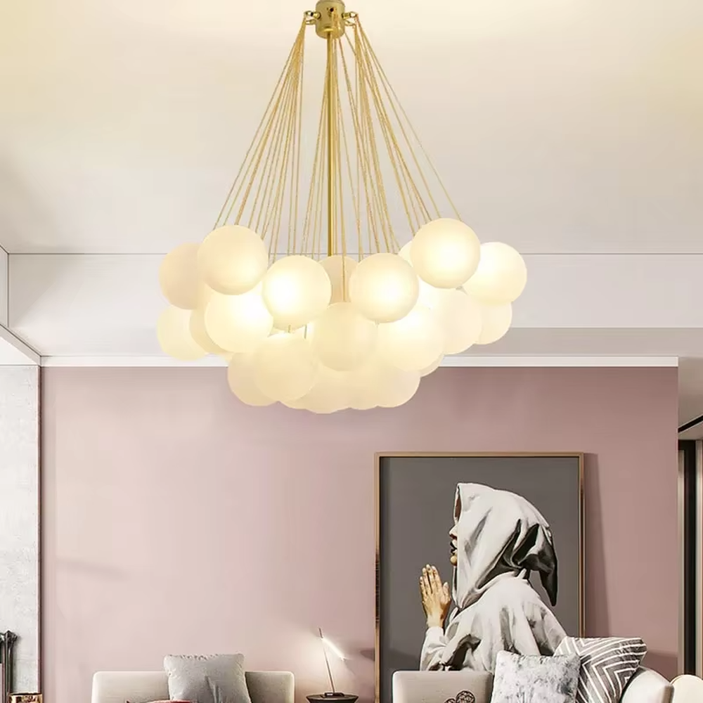 Modern light luxury cloud-shaped chandelier, with a golden metal frame and milky white glass ball lampshades stacked into a full cloud shape, featuring soft and warm light, combining decorative and lighting functions, suitable for living rooms, dining rooms, bedrooms and other modern style spaces.