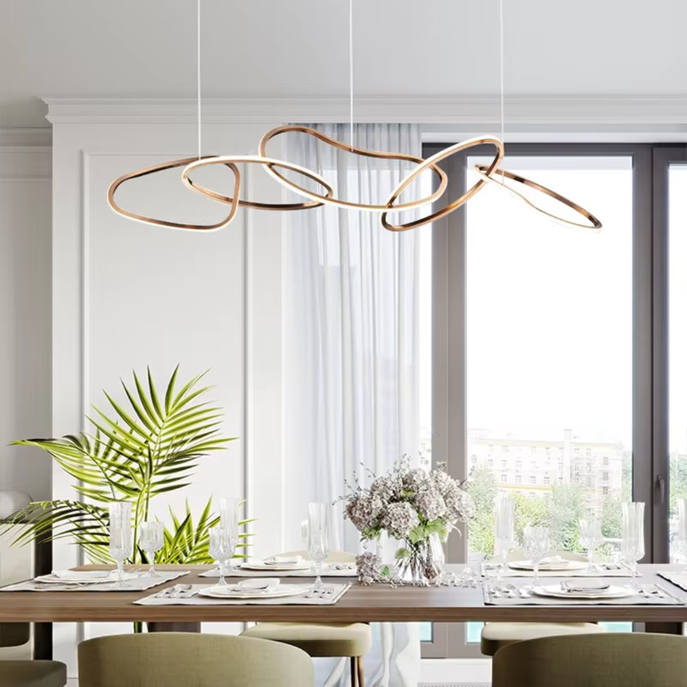 Modern light luxury flowing ring chandelier, featuring interwoven and irregular gold metal rings with built-in soft LED lighting. Its dynamic and elegant lines combine artistry and ambiance, making it a high-end decorative lighting fixture that elevates the space's style.