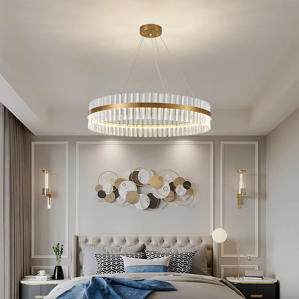 This modern light luxury circular crystal chandelier features a gold metal frame, inlaid with transparent long crystals to form a double-layered circular shape. When lit, light refracts through the crystal to emit a brilliant and soft glow, combining an exquisite texture with an ambient atmosphere. Ideal for living rooms, dining rooms, light luxury apartments, and other spaces, it adds an exquisite and sophisticated touch to modern minimalist or light luxury home environments.