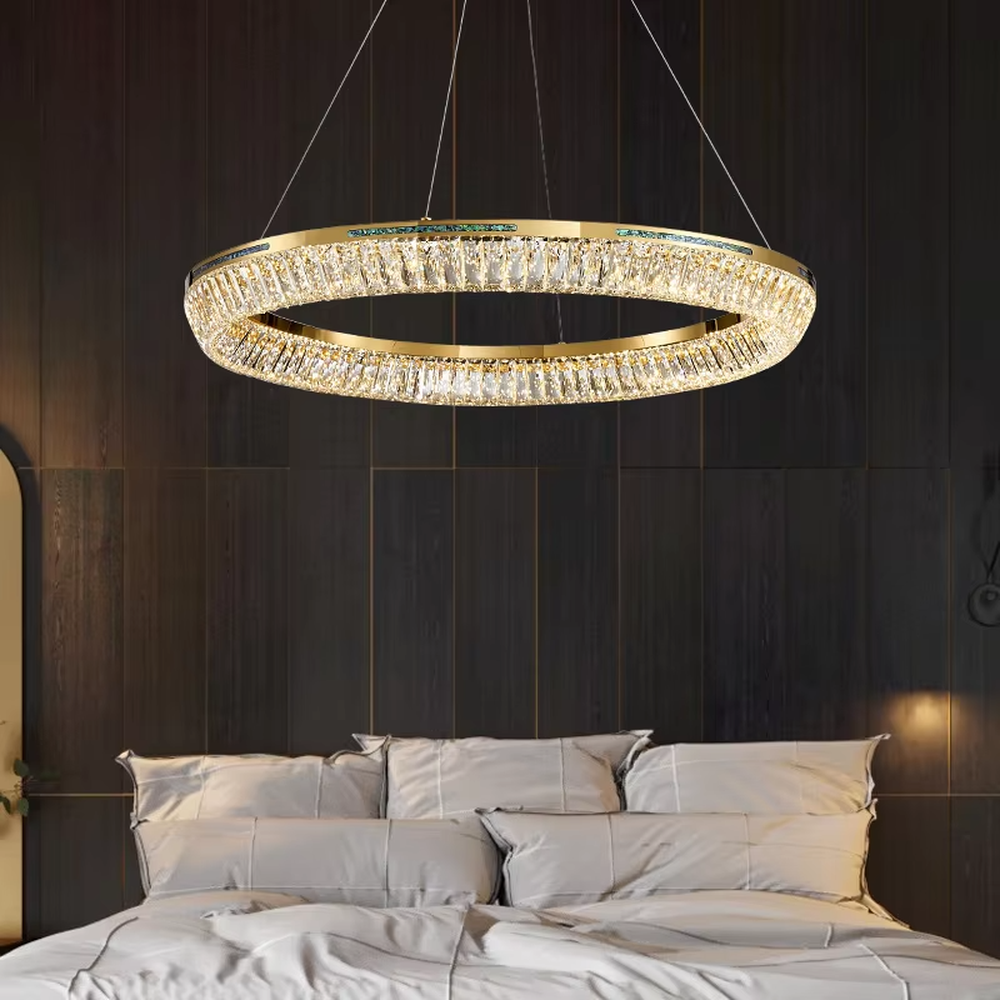 This modern light luxury multi-layered ring crystal chandelier features a gold metal frame, with each ring inlaid with transparent long crystals arranged in concentric circles. When lit, light refracts through the crystal to emit a brilliant and luxurious glow, combining layered design with an ambient atmosphere. Ideal for high-ceiling living rooms, villa foyers, hotel lobbies, and other spaces, it adds an elegant and exquisite touch to modern light luxury or European-style luxury environments.