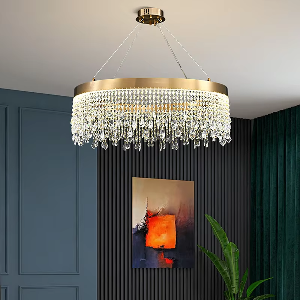 This modern light luxury circular tassel crystal chandelier features a champagne gold metal top frame, with dense crystal bead strings hanging down to form a tassel layered shape. When lit, light refracts through the crystals to emit a brilliant and soft glow, combining a luxurious texture with an ambient atmosphere. Ideal for living rooms, dining rooms, light luxury apartments, and other spaces, it adds an exquisite and sophisticated touch to modern minimalist or light luxury home environments.