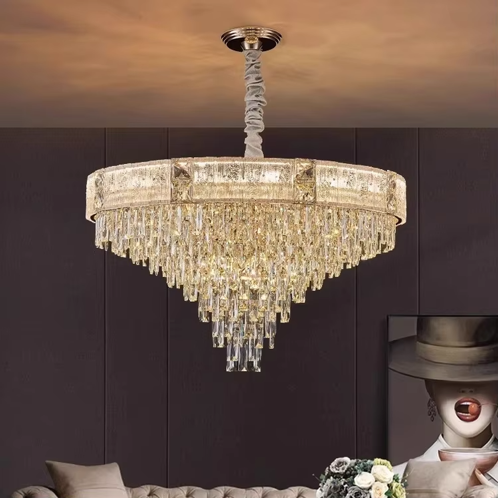 This light luxury and grand multi-layer conical crystal chandelier features a gold metal frame, with vertical-textured glass lampshades on the upper layer and multiple layers of transparent crystal tassels hanging below, creating a full conical shape. When lit, light refracts through the crystal to emit a brilliant and luxurious glow, combining elegant texture with an ambient atmosphere. Ideal for living rooms, dining rooms, villa high-ceiling spaces, and other areas, it adds an elegant and exquisite touch to European light luxury or modern luxury home environments.