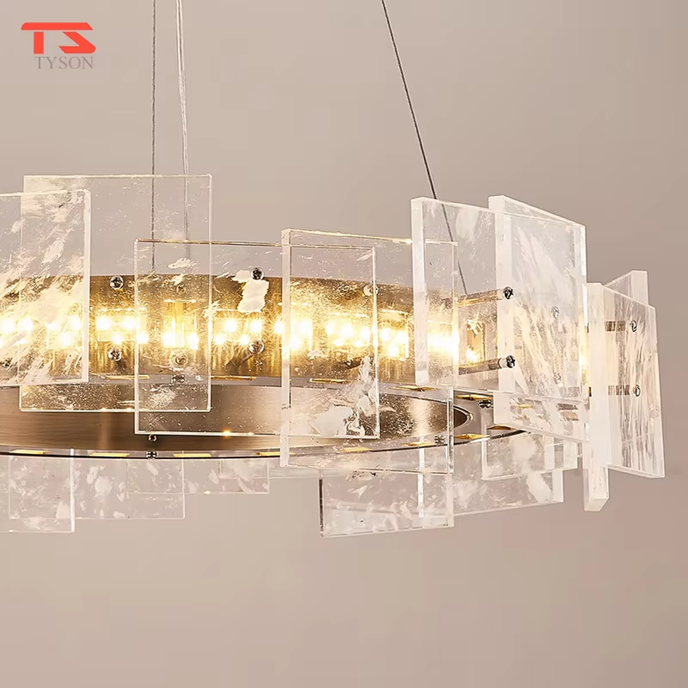 Modern light luxury ice crystal ring chandelier, featuring a gold metal frame paired with staggered ice-crystal textured acrylic panels. Light refracts through the panels to create a brilliant and soft glow, combining luxury texture and artistic ambiance, making it a high-end decorative lighting fixture that elevates the space's style.