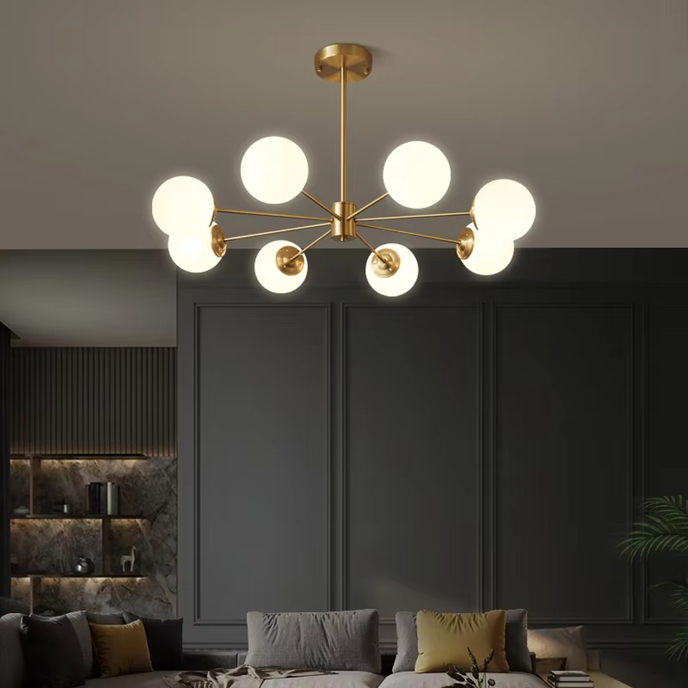 Modern light luxury magic bean chandelier, featuring a radial frame in black and gold metal paired with milk-white frosted glass ball lampshades. Its minimalist, rounded, and layered design combines warmth and style, making it a decorative lighting fixture that enhances the space's texture.