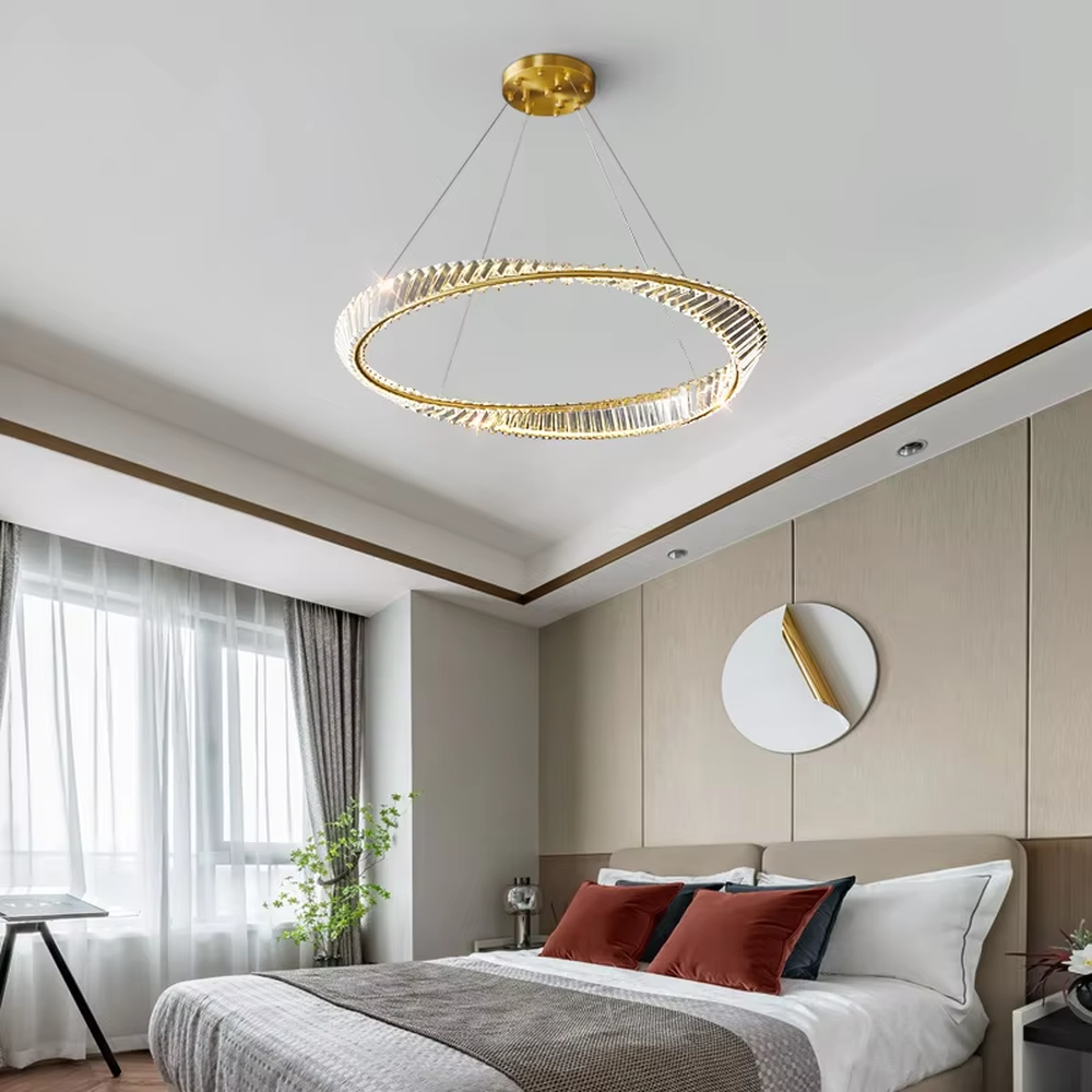 This modern light luxury interwoven ring crystal chandelier features a gold metal frame, inlaid with transparent long crystals to create a dynamic interwoven double-ring shape. When lit, light refracts through the crystal to emit a brilliant and soft glow, combining a futuristic feel with an ambient atmosphere. Ideal for dining rooms, living rooms, light luxury apartments, and other spaces, it adds an exquisite and sophisticated touch to modern minimalist or light luxury home environments.