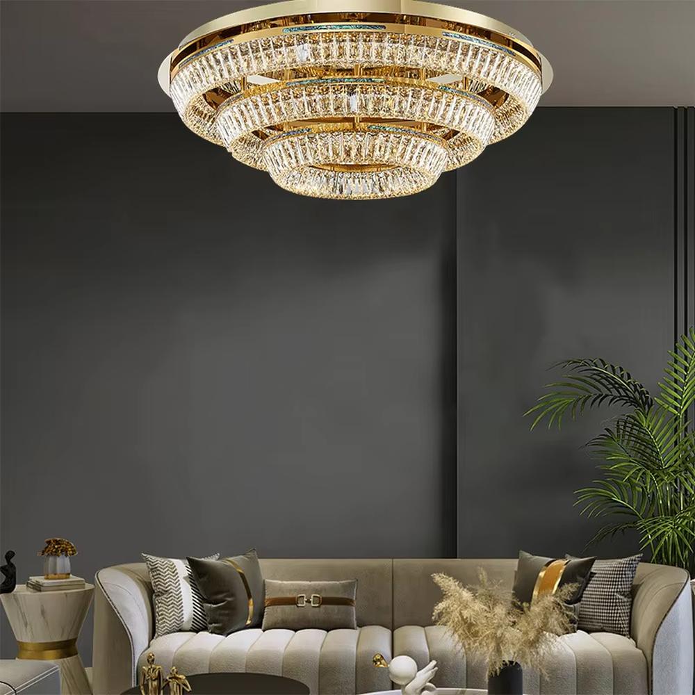 This modern light luxury multi-layered ring crystal chandelier features a gold metal frame, with each ring inlaid with transparent long crystals arranged in concentric circles. When lit, light refracts through the crystal to emit a brilliant and luxurious glow, combining layered design with an ambient atmosphere. Ideal for high-ceiling living rooms, villa foyers, hotel lobbies, and other spaces, it adds an elegant and exquisite touch to modern light luxury or European-style luxury environments.