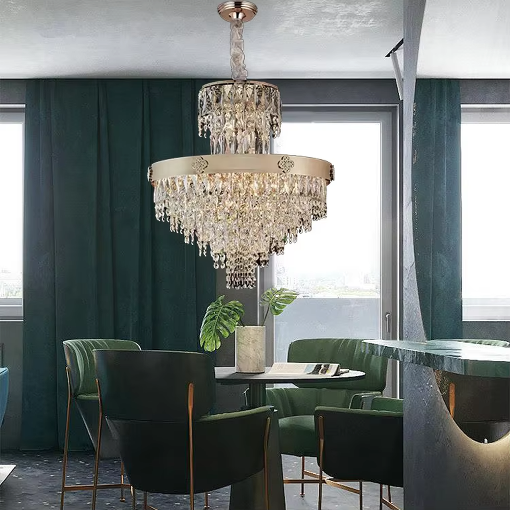 This European luxury two-layer conical crystal chandelier features a champagne gold metal frame, with dense long crystals hanging down to form a two-layer conical layered shape, suspended by a braided cord. When lit, light refracts through the crystals to emit a brilliant and luxurious glow, combining a luxurious texture with an ambient atmosphere. Ideal for villa living rooms, luxury dining rooms, high-end clubs, and other spaces, it adds an elegant and exquisite touch to European luxury or modern light luxury environments.