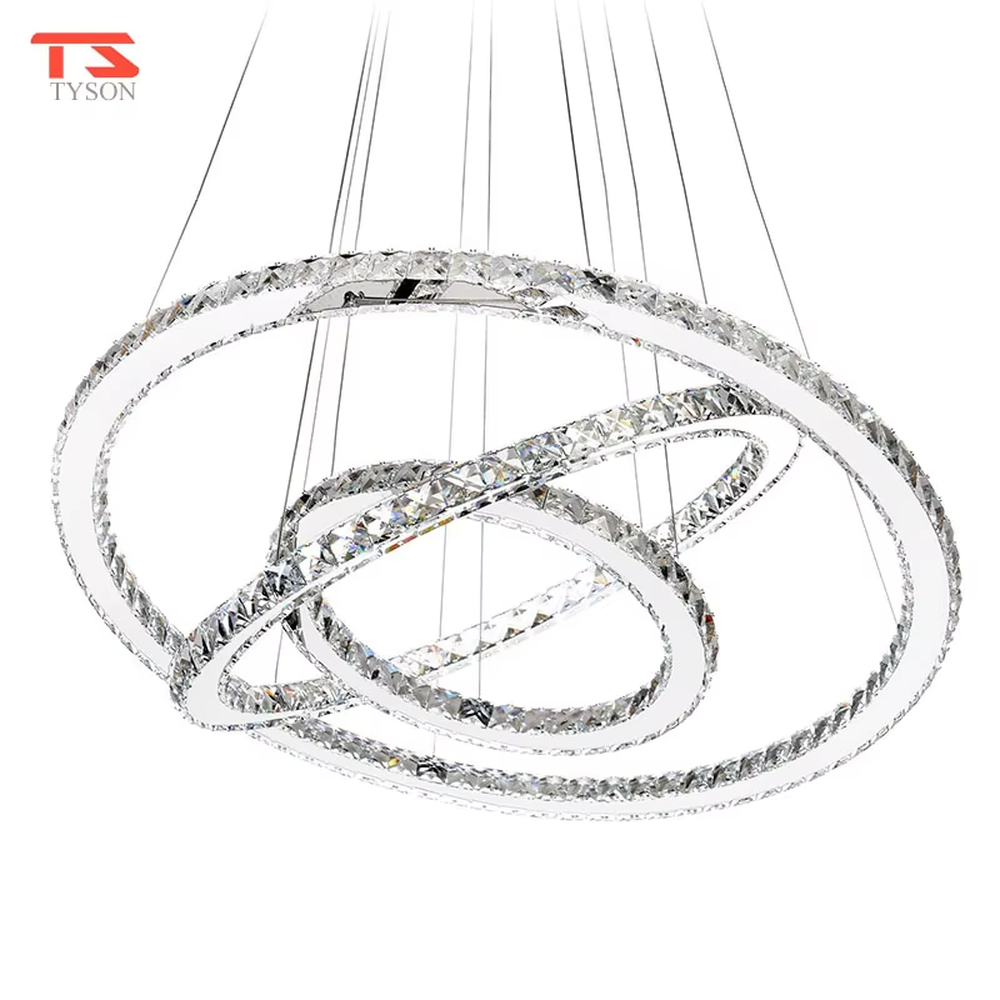 This modern light luxury interwoven ring crystal chandelier consists of transparent crystal rings of varying sizes interlaced and nested, suspended by silver cords. When lit, light refracts through the crystal to emit a brilliant and dynamic glow, combining a futuristic feel with an ambient atmosphere. Ideal for high-ceiling living rooms, villa foyers, light luxury apartments, and other spaces, it adds an exquisite and sophisticated touch to modern minimalist or light luxury environments.