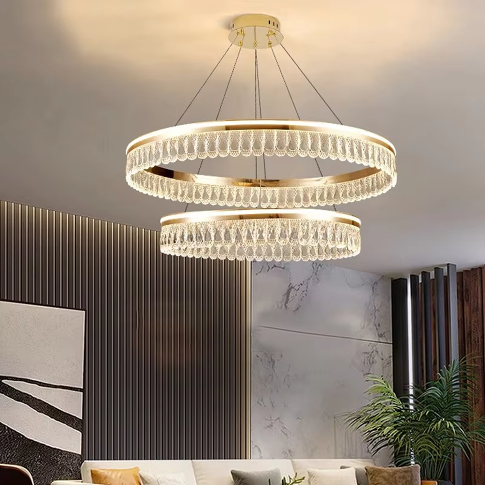 Modern light luxury double-layer ring crystal chandelier, featuring a rose gold metal frame paired with dense crystal strips to create a double-layer suspended shape. Light refracts through the crystals to produce a brilliant and soft glow, combining sophistication and ambiance, making it a high-end decorative lighting fixture that elevates the space's style.