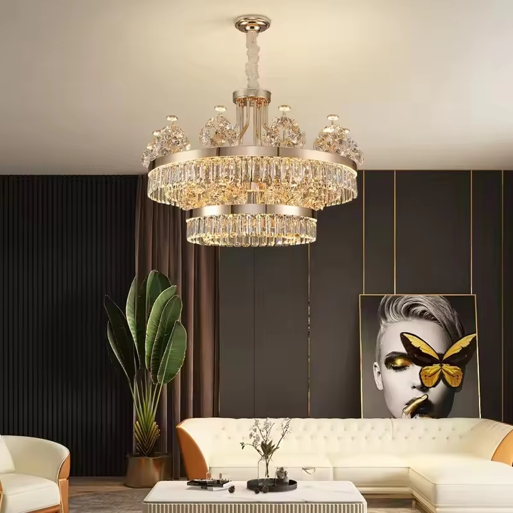 This modern light luxury two-layer crystal chandelier features a gold metal frame, with dense transparent long crystals hanging below and leaf-textured crystal lampshades on top. When lit, light refracts through the crystal to emit a brilliant and soft glow, combining an ethereal texture with an ambient atmosphere. Ideal for living rooms, dining rooms, light luxury apartments, and other spaces, it adds an exquisite and sophisticated touch to modern minimalist or light luxury home environments.