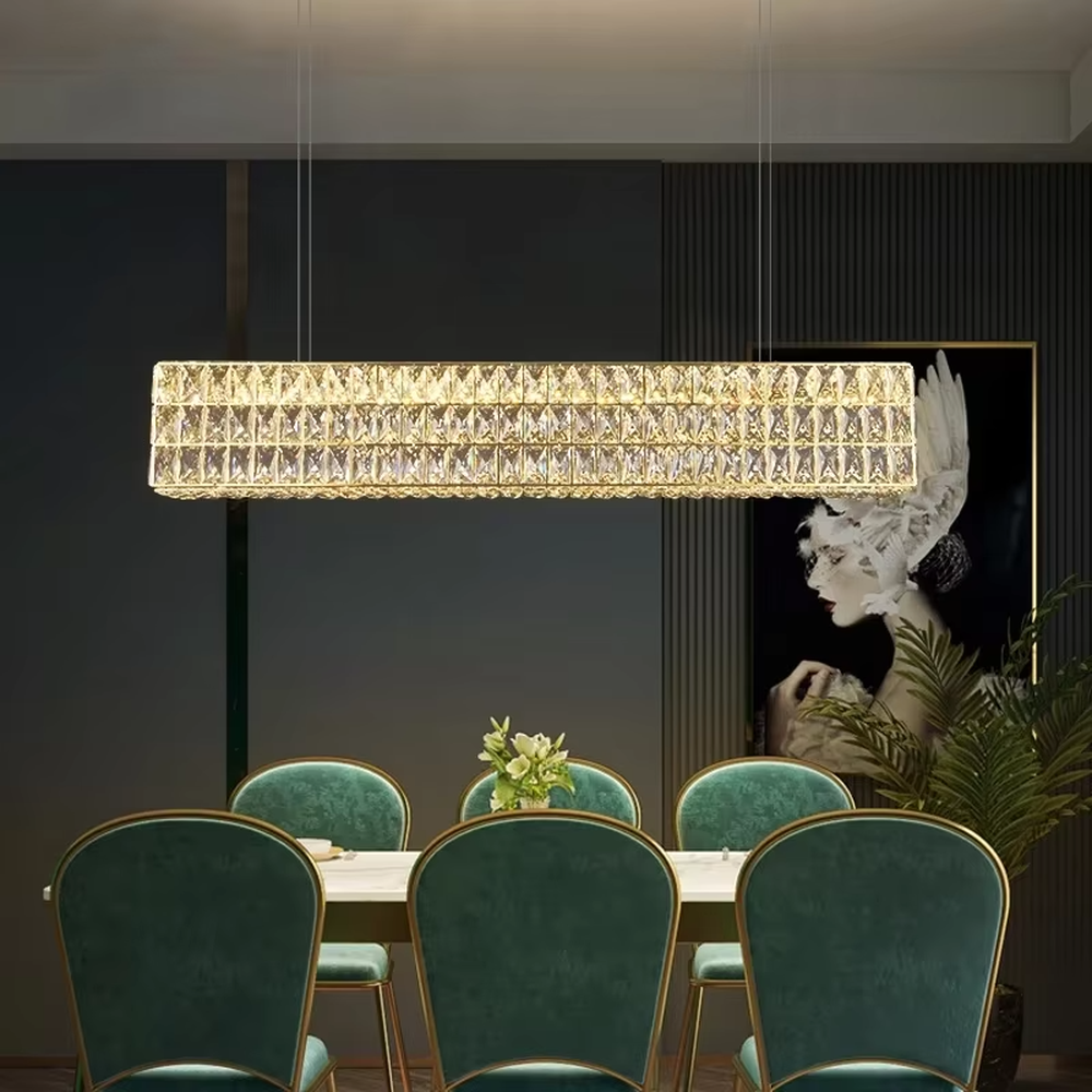 This modern light luxury linear crystal chandelier features a gold metal frame, inlaid with two layers of cut crystal blocks to form a square shape. When lit, light refracts through the crystals to emit a brilliant and luxurious glow, combining an exquisite texture with an ambient atmosphere. Ideal for dining rooms, bars, light luxury apartments, and other spaces, it adds an exquisite and sophisticated touch to modern minimalist or light luxury home environments.
