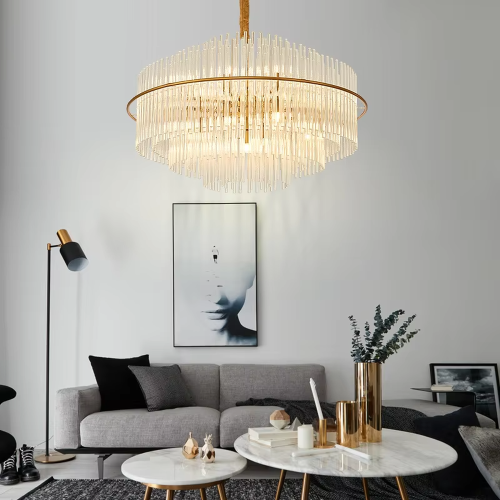 This modern light luxury square chandelier features a gold metal frame, with dense transparent glass strips hanging down to form a staggered three-dimensional shape. When lit, light refracts through the glass to emit a soft and even glow, combining a minimalist texture with an ambient atmosphere. Ideal for living rooms, dining rooms, light luxury apartments, and other spaces, it adds an exquisite and sophisticated touch to modern minimalist or Scandinavian-style home environments.