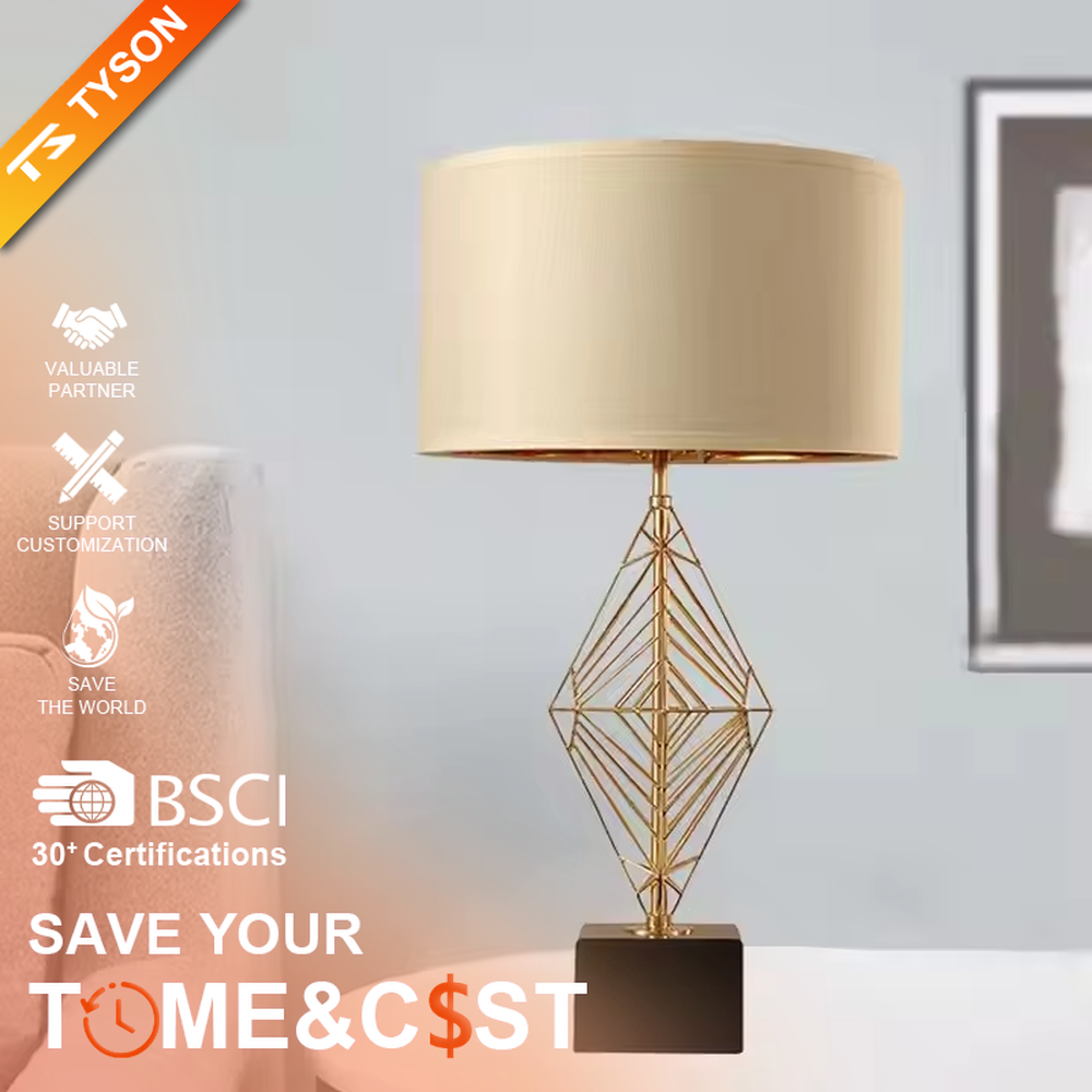This is a luxury geometric diamond-shaped table lamp with a golden geometric hollow diamond bracket and a beige fabric lampshade. It features a simple and elegant design with excellent texture. It is used for local desktop lighting and decoration, creating a luxurious and warm ambiance. It is suitable for luxury-style home bedroom bedside tables, high-end hotel guest rooms, modern soft decoration display spaces and other places.