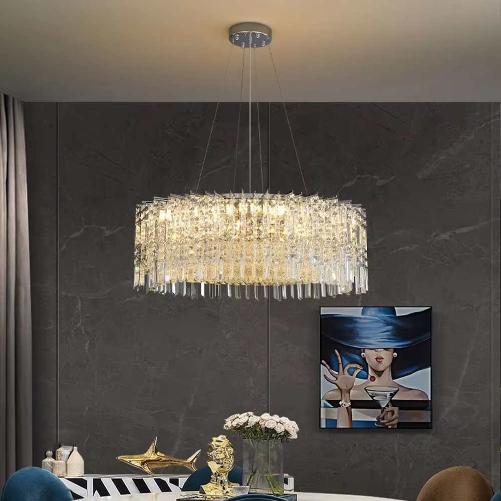 This modern light luxury square crystal chandelier features a silver metal frame, with dense transparent long crystals hanging down to form a square shape. When lit, light refracts through the crystal to emit a brilliant and soft glow, combining an exquisite texture with an ambient atmosphere. Ideal for bedrooms, dining rooms, light luxury apartments, and other spaces, it adds an exquisite and sophisticated touch to modern minimalist or light luxury home environments.