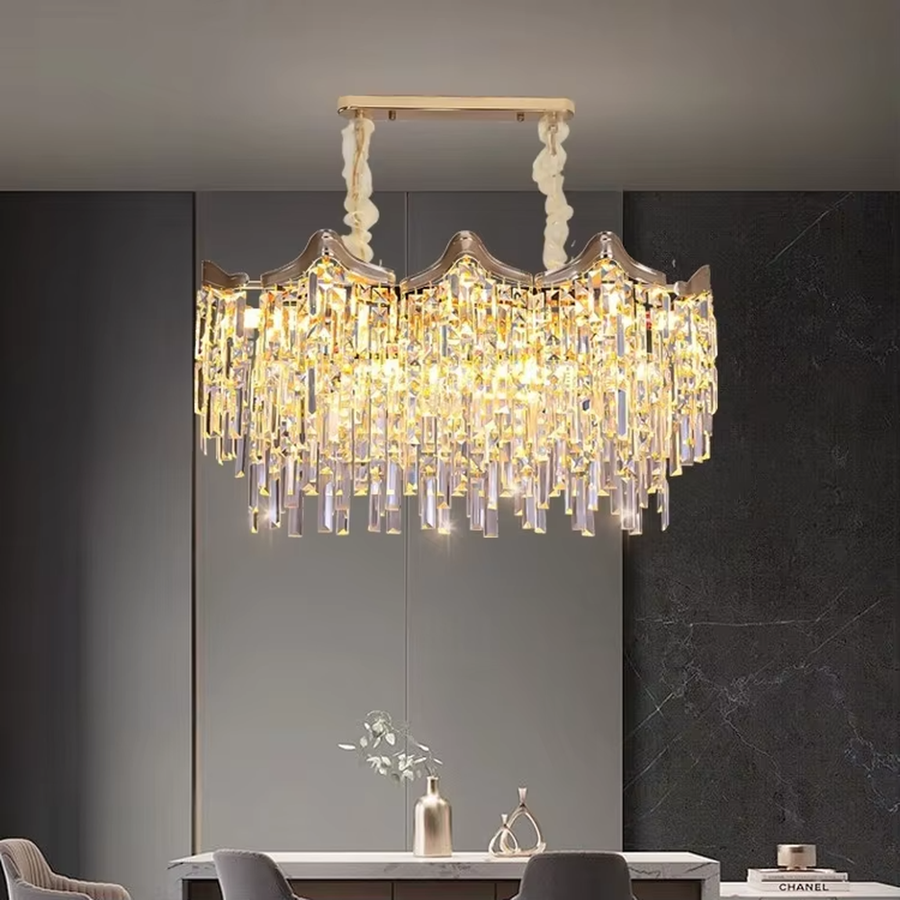 This European luxury fan-shaped crystal chandelier features a champagne gold metal frame, with dense long crystals hanging down to form a layered fan shape, suspended by a braided cord. When lit, light refracts through the crystal to emit a brilliant and luxurious glow, combining a luxurious texture with an ambient atmosphere. Ideal for villa living rooms, luxury dining rooms, high-end clubs, and other spaces, it adds an elegant and exquisite touch to European luxury or modern light luxury environments.