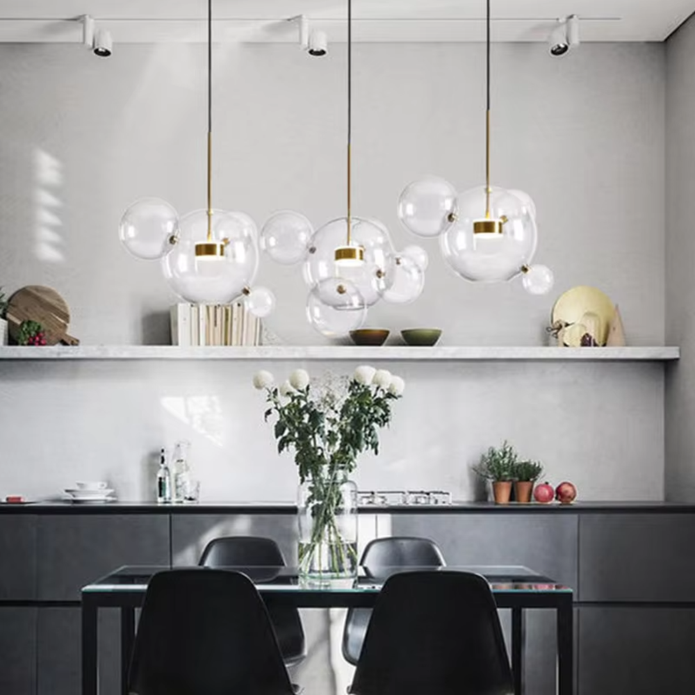 Modern art bubble cluster chandelier, featuring a cloud-like arrangement of transparent glass bubbles paired with black and gold suspension wires. Light refracts through the bubbles to create a soft and translucent glow, combining a dreamy feel and artistic ambiance, making it a high-end decorative lighting fixture that elevates the space's style.