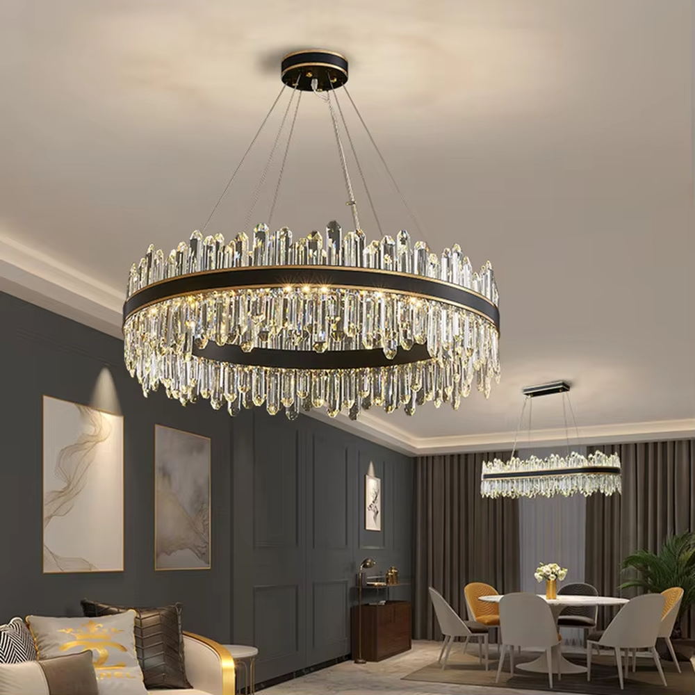 This modern light luxury two-layer circular crystal chandelier features a black-gold metal frame, with dense transparent long crystals hanging down to form a full circular shape. When lit, light refracts through the crystal to emit a brilliant and luxurious glow, combining a bold texture with an ambient atmosphere. Ideal for living rooms, dining rooms, light luxury apartments, and other spaces, it adds an exquisite and sophisticated touch to modern minimalist or light luxury home environments.