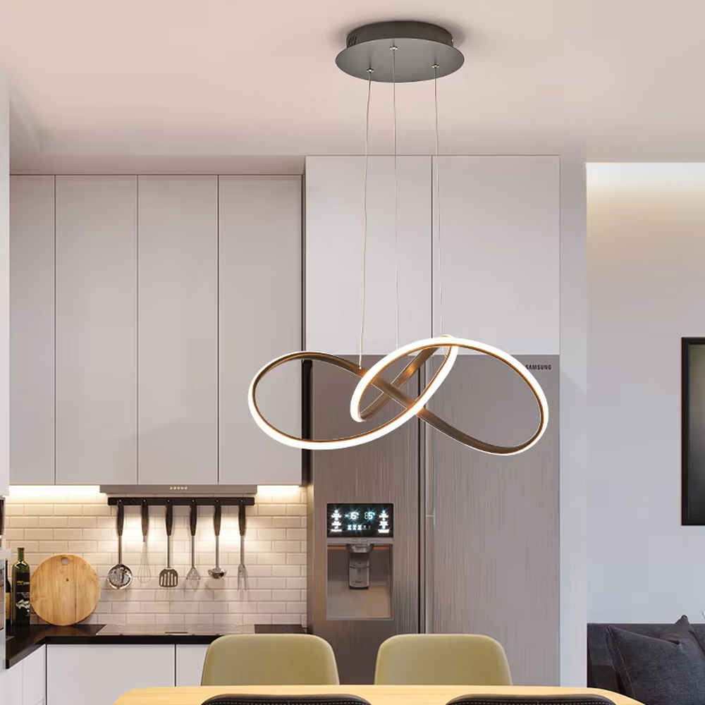 Modern light luxury interlocking double-ring chandelier, featuring a fluid interwoven ring structure in black and gold metal with built-in soft LED lighting. Its dynamic and elegant lines combine style and ambiance, making it a modern home lighting fixture that elevates the space's aesthetic.