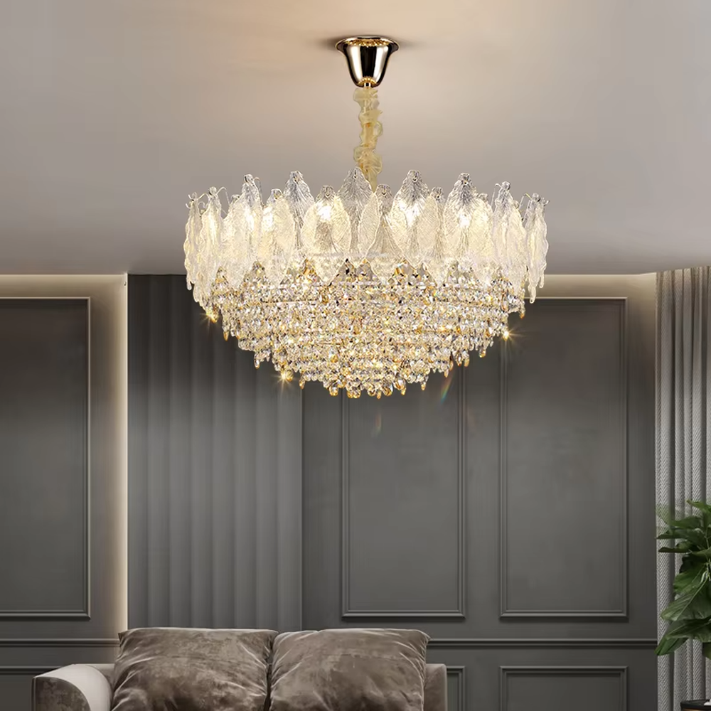 This modern light luxury two-layer chandelier features an upper layer of transparent leaf-textured glass lampshades and a lower layer of dense crystal tassels, forming a full flower crown shape. When lit, light refracts through the crystal and glass to emit a brilliant and soft glow, combining an ethereal texture with an ambient atmosphere. Ideal for living rooms, dining rooms, light luxury apartments, and other spaces, it adds a dreamy and exquisite touch to modern minimalist or French light luxury home environments.