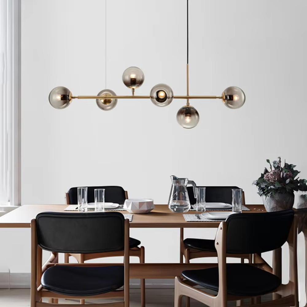 Modern light luxury molecular structure chandelier, featuring a linear brass metal frame paired with gradient smoky gray glass ball lampshades. Its minimalist and layered design combines style and ambiance, making it a decorative lighting fixture that elevates the space's aesthetic.
