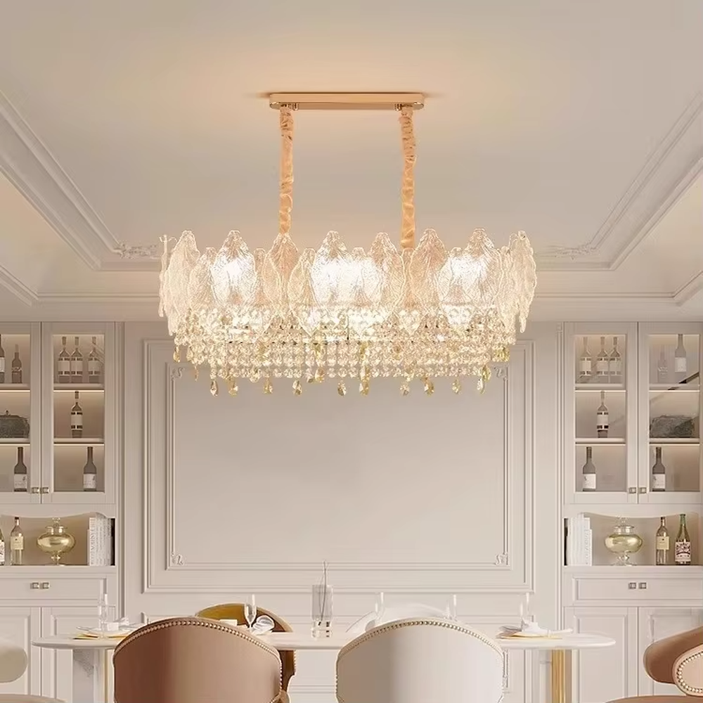 This modern light luxury two-layer chandelier features an upper layer of transparent leaf-textured glass lampshades and a lower layer of dense crystal tassels, forming a full flower crown shape. When lit, light refracts through the crystal and glass to emit a brilliant and soft glow, combining an ethereal texture with an ambient atmosphere. Ideal for living rooms, dining rooms, light luxury apartments, and other spaces, it adds a dreamy and exquisite touch to modern minimalist or French light luxury home environments.