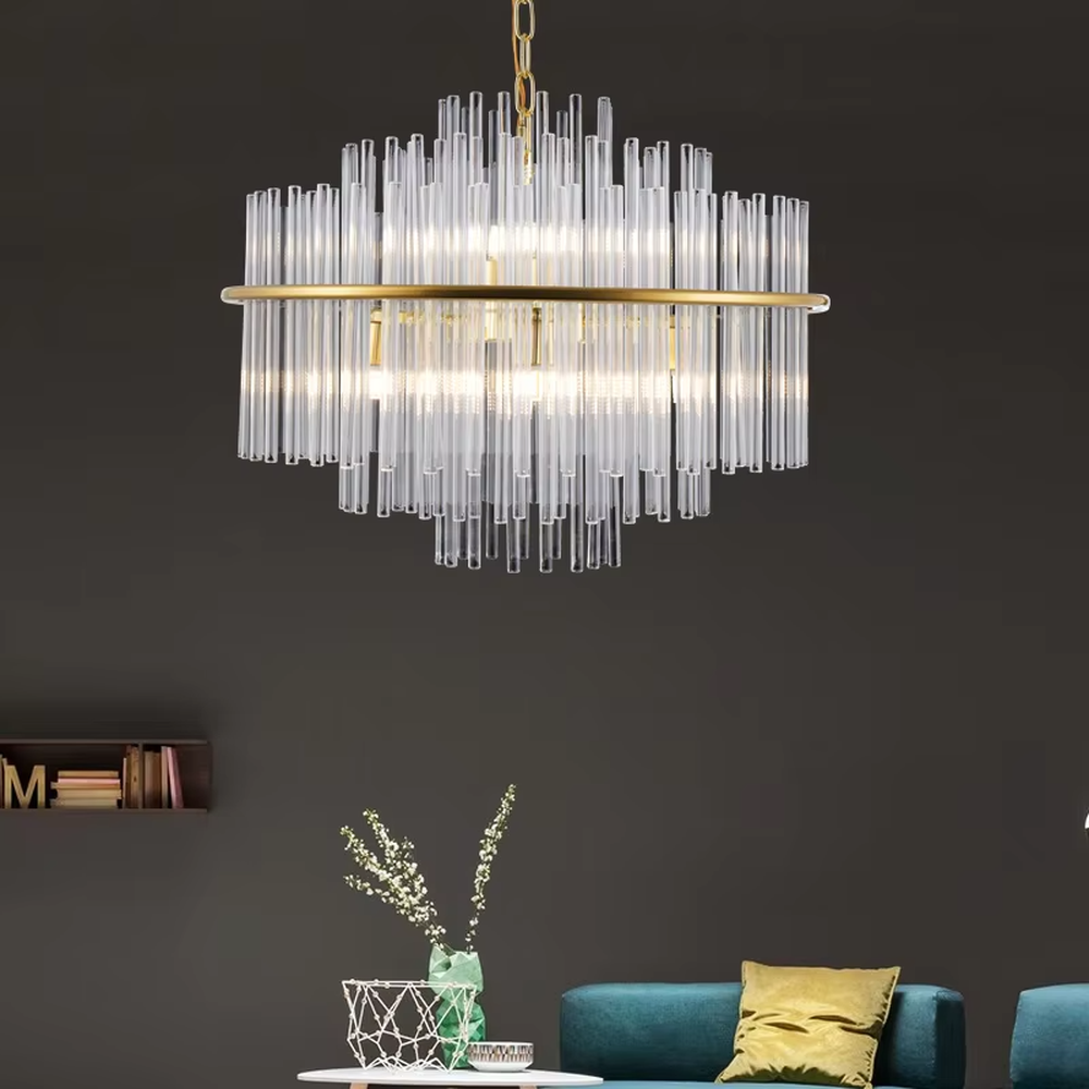 This modern light luxury square chandelier features a gold metal frame, with dense transparent glass strips hanging down to form a staggered three-dimensional shape. When lit, light refracts through the glass to emit a soft and even glow, combining a minimalist texture with an ambient atmosphere. Ideal for living rooms, dining rooms, light luxury apartments, and other spaces, it adds an exquisite and sophisticated touch to modern minimalist or Scandinavian-style home environments.