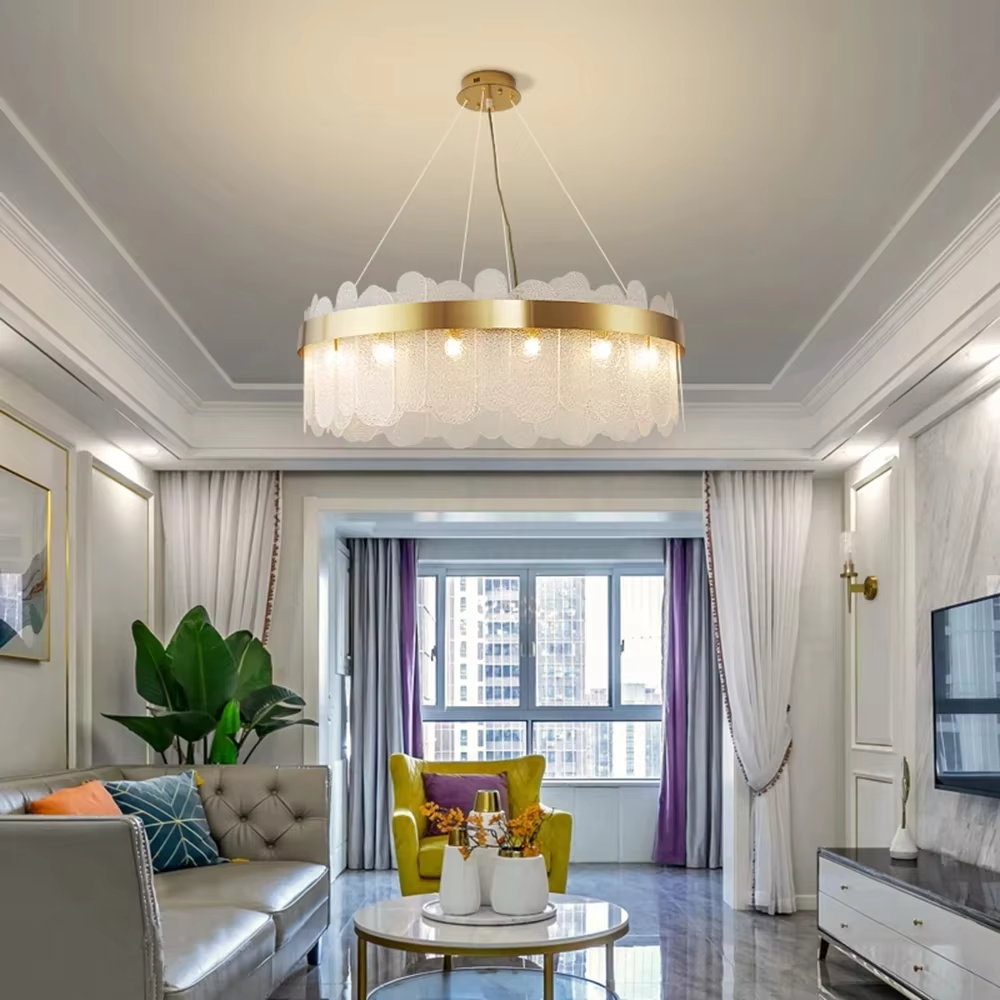 Modern light luxury smoky gray glass chandelier, featuring a ring frame in gold metal paired with layered smoky gray curved glass panels. Light refracts through the glass to create a soft and translucent glow, combining sophistication and ambiance, making it a decorative lighting fixture that elevates the space's style.
