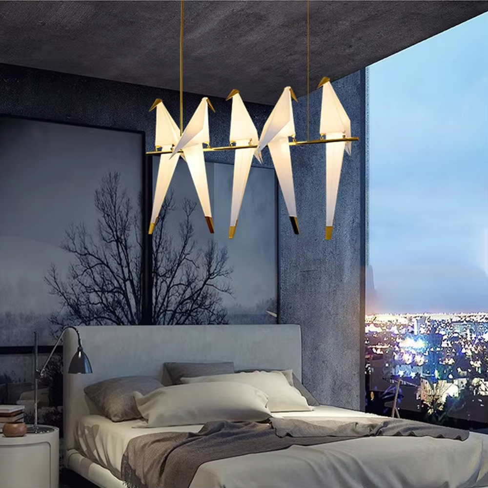Modern art origami crane chandelier, featuring a gold metal frame paired with white origami crane-shaped lampshades made using paper folding techniques. Its elegant and dynamic lines combine artistry and ambiance, making it a decorative lighting fixture that elevates the space's style.