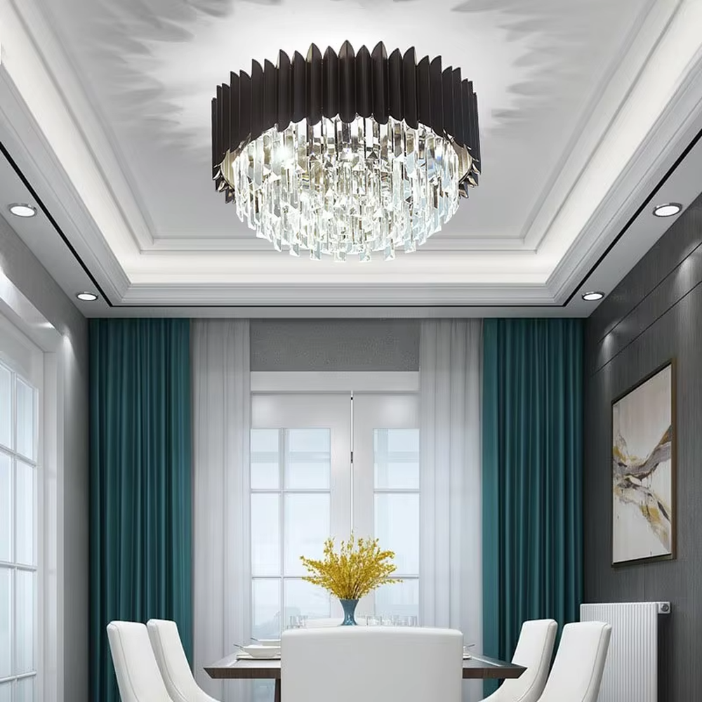 This modern light luxury two-layer chandelier features a dome shape enclosed by matte black vertical-textured metal on the upper layer, paired with transparent crystal tassel pendants on the lower layer, suspended by a black braided cord. When lit, light refracts through the crystal to emit a brilliant and soft glow, combining a sleek, bold texture with an elegant ambiance. Ideal for dining rooms, bedrooms, light luxury living rooms, and other spaces, it adds an exquisite and sophisticated touch to modern minimalist or industrial-style home environments.