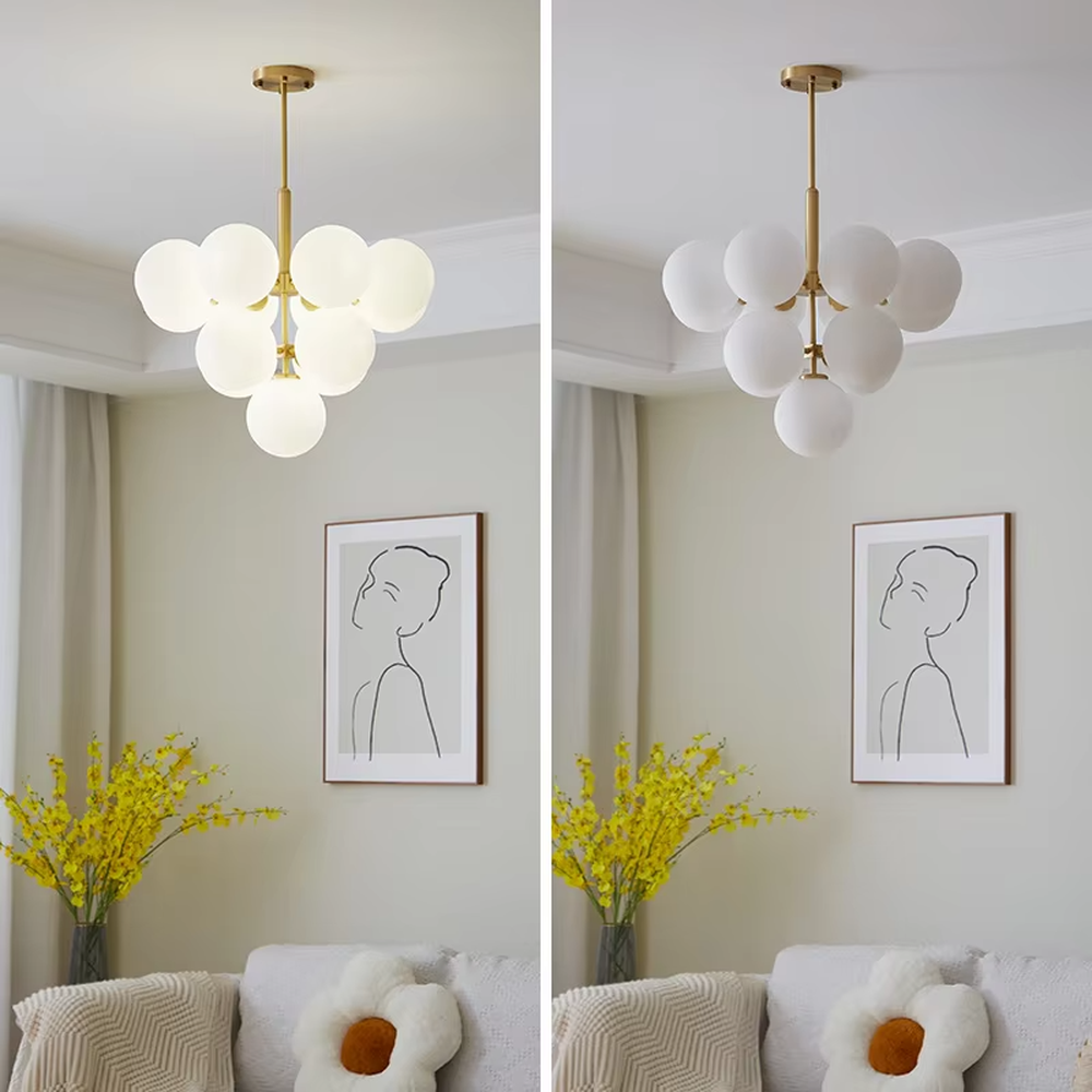Modern light luxury gold magic bean chandelier, featuring a brass metal frame paired with clustered milk-white frosted glass balls. It emits soft and gentle light, combining warmth and style, making it a decorative lighting fixture that enhances the space's texture.