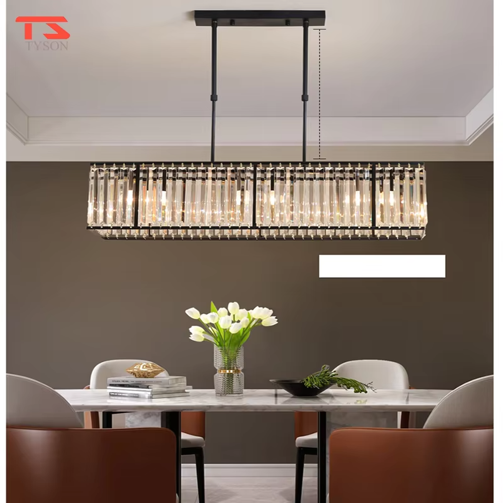 This modern light luxury linear crystal chandelier features a black metal frame, inlaid with transparent long crystals to form a rectangular shape, paired with height-adjustable black suspension wires. When lit, light refracts through the crystal to emit a brilliant and luxurious glow, combining a bold texture with an elegant ambiance. Ideal for dining rooms, bars, light luxury apartments, and other spaces, it adds an exquisite and sophisticated touch to modern minimalist or industrial-style home environments.