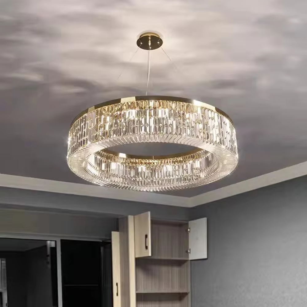 This modern light luxury two-layer circular crystal chandelier features a gold metal frame, inlaid with transparent long crystals to form a double-layered circular shape. When lit, light refracts through the crystal to emit a brilliant and soft glow, combining an exquisite texture with an ambient atmosphere. Ideal for living rooms, dining rooms, light luxury apartments, and other spaces, it adds an exquisite and sophisticated touch to modern minimalist or light luxury home environments.
