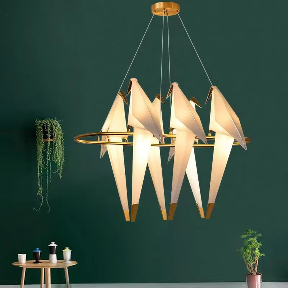 Modern art origami crane chandelier, featuring a gold metal frame paired with white origami crane-shaped lampshades made using paper folding techniques. Its elegant and dynamic lines combine artistry and ambiance, making it a decorative lighting fixture that elevates the space's style.