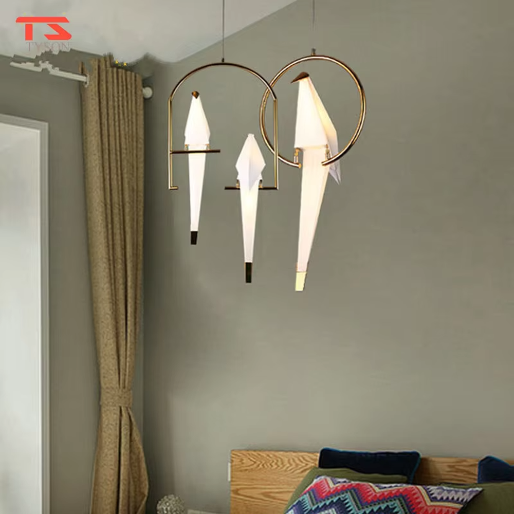 Modern art origami crane cage chandelier, featuring an arched gold metal frame paired with a white origami crane lampshade made with paper folding techniques. Its elegant and dynamic lines combine artistry and ambiance, making it a decorative lighting fixture that elevates the space's style.