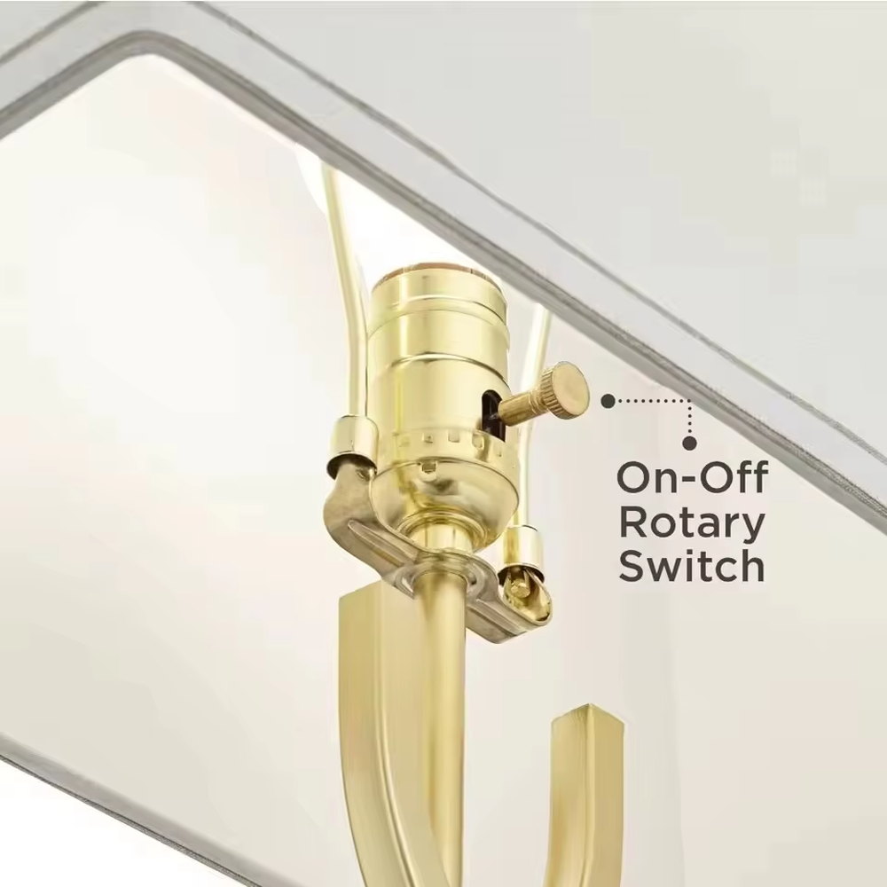 This is a luxury-style table lamp with a golden geometric hollow bracket and a white fabric square lampshade. It features a simple and elegant design with excellent texture. It is used for local desktop lighting and decoration, creating a luxurious and warm ambiance. It is suitable for luxury-style home bedroom bedside tables, high-end hotel guest rooms, modern office spaces and other places.