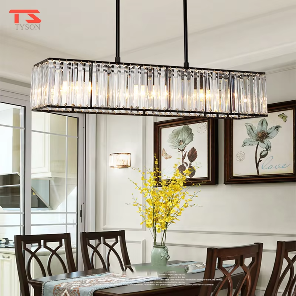 This modern light luxury linear crystal chandelier features a black metal frame, inlaid with transparent long crystals to form a rectangular shape, paired with height-adjustable black suspension wires. When lit, light refracts through the crystal to emit a brilliant and luxurious glow, combining a bold texture with an elegant ambiance. Ideal for dining rooms, bars, light luxury apartments, and other spaces, it adds an exquisite and sophisticated touch to modern minimalist or industrial-style home environments.