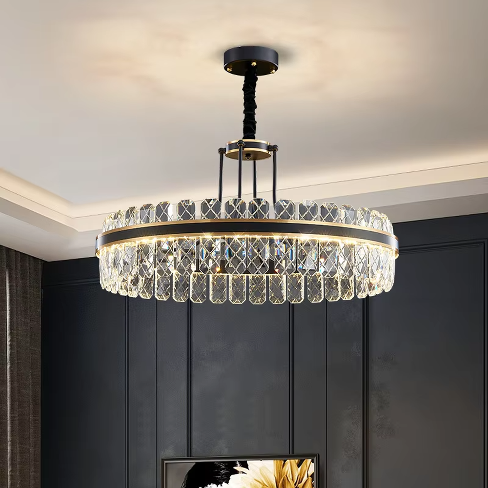 This modern light luxury two-layer circular crystal chandelier features a black metal frame, inlaid with transparent crystal strips with diamond textures to form a double-layered circular shape, paired with a height-adjustable black suspension rod. When lit, light refracts through the crystal to emit a brilliant and luxurious glow, combining a bold texture with an ambient atmosphere. Ideal for living rooms, dining rooms, light luxury apartments, and other spaces, it adds an exquisite and sophisticated touch to modern minimalist or industrial-style home environments.