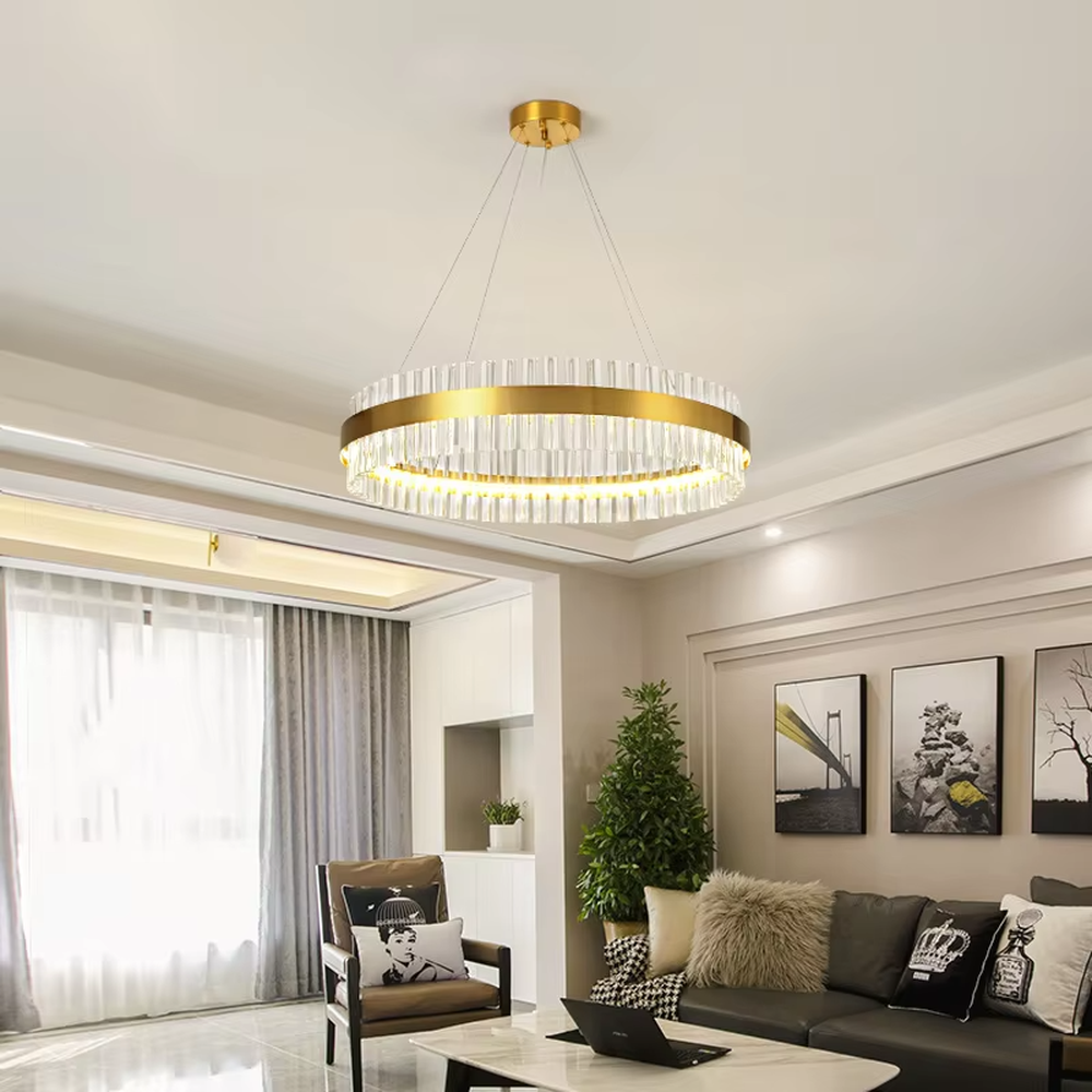 This modern light luxury circular crystal chandelier features a gold metal frame, inlaid with transparent long crystals to form a double-layered circular shape. When lit, light refracts through the crystal to emit a brilliant and soft glow, combining an exquisite texture with an ambient atmosphere. Ideal for living rooms, dining rooms, light luxury apartments, and other spaces, it adds an exquisite and sophisticated touch to modern minimalist or light luxury home environments.