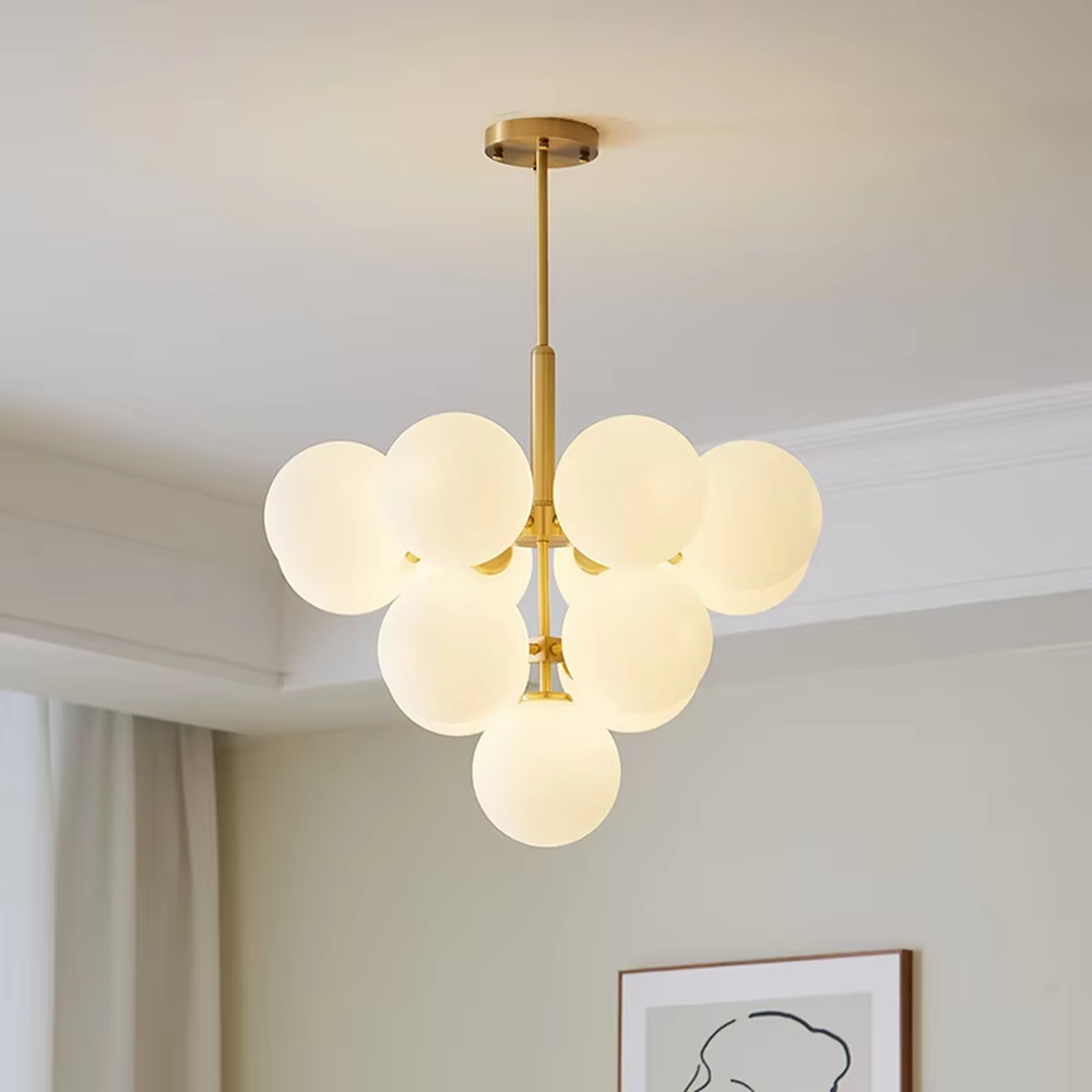 Modern light luxury gold magic bean chandelier, featuring a brass metal frame paired with clustered milk-white frosted glass balls. It emits soft and gentle light, combining warmth and style, making it a decorative lighting fixture that enhances the space's texture.
