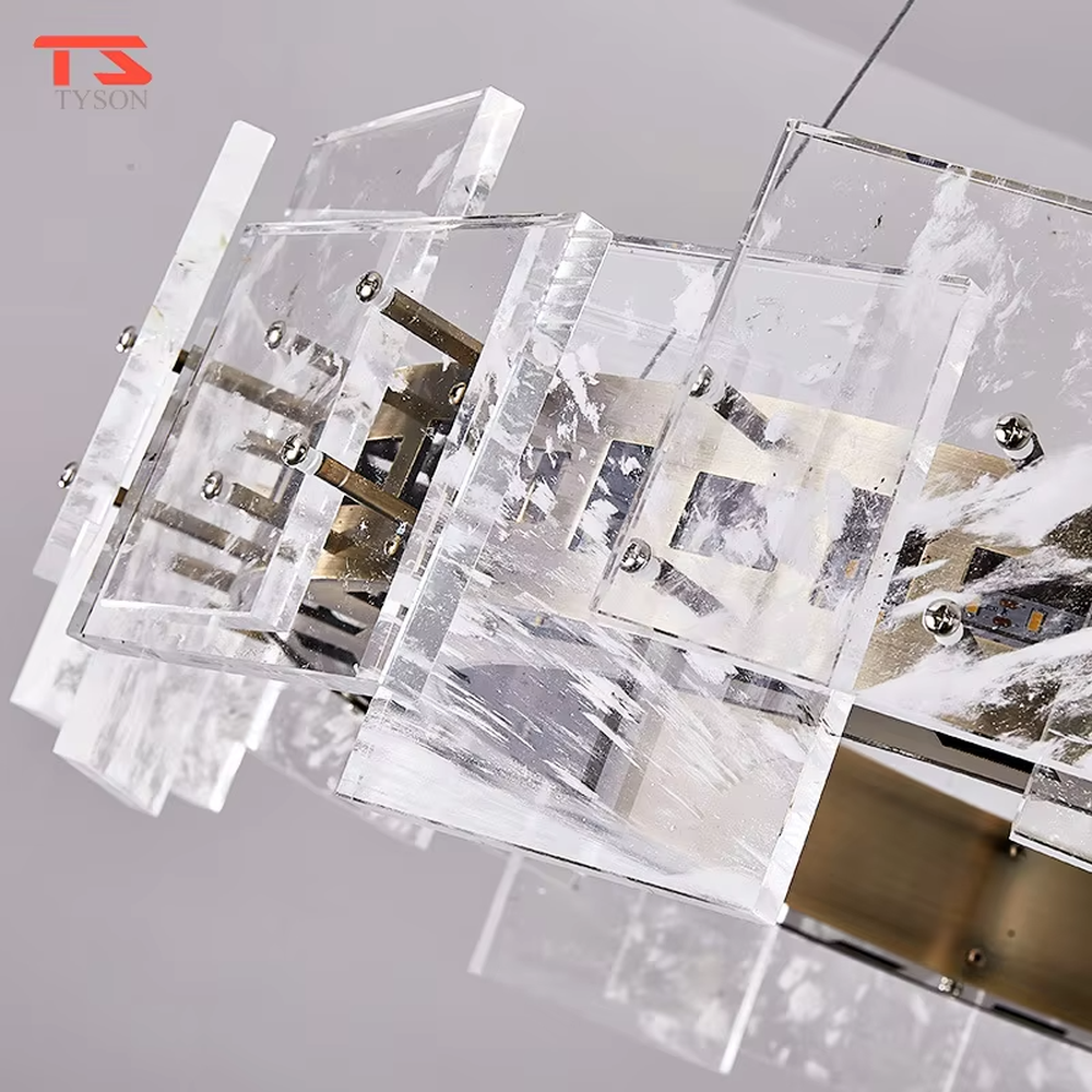 Modern light luxury ice crystal ring chandelier, featuring a gold metal frame paired with staggered ice-crystal textured acrylic panels. Light refracts through the panels to create a brilliant and soft glow, combining luxury texture and artistic ambiance, making it a high-end decorative lighting fixture that elevates the space's style.