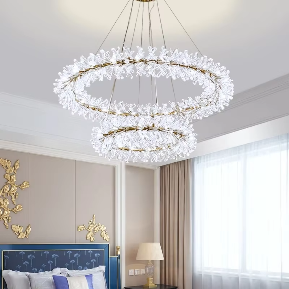 This modern light luxury multi-layer circular chandelier features a gold metal frame, inlaid with transparent snowflake-shaped crystal modules, combined into a three-layer staggered circular shape. When lit, light refracts through the crystal to emit a brilliant and soft glow, combining an ethereal feel with an ambient atmosphere. Ideal for living rooms, dining rooms, light luxury apartments, and other spaces, it adds a dreamy and exquisite touch to modern minimalist or French light luxury home environments.