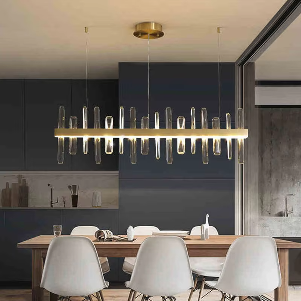 This modern light luxury circular crystal chandelier features a gold metal frame, with transparent crystal strips of varying lengths hanging down to form a staggered circular shape. When lit, light refracts through the crystal to emit a brilliant and dynamic glow, combining an exquisite texture with an ambient atmosphere. Ideal for dining rooms, living rooms, light luxury apartments, and other spaces, it adds an exquisite and sophisticated touch to modern minimalist or light luxury home environments.